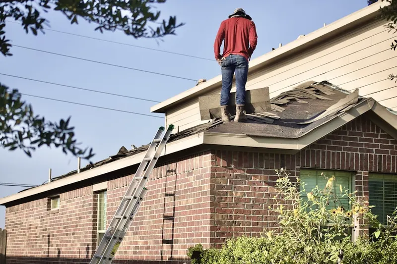Professional roofer working on a residential roof in Smartville